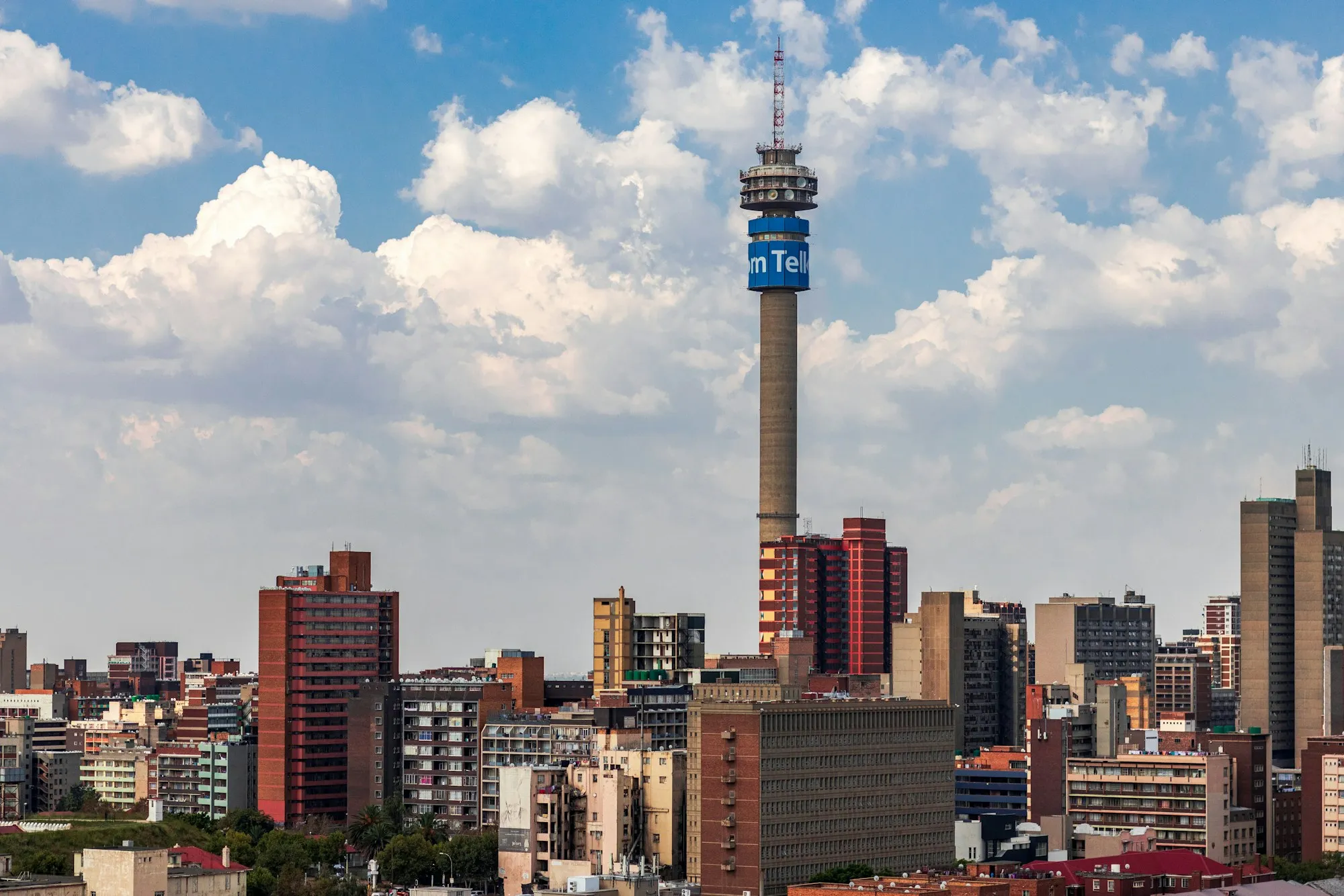 The Johannesburg skyline under a bright blue sky